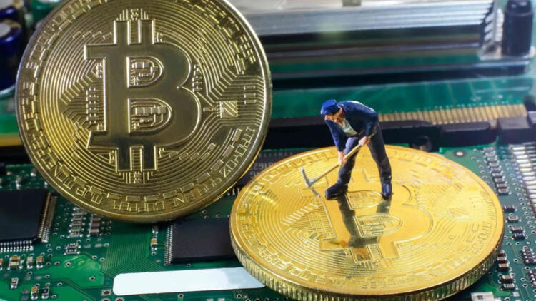 Bitcoin being mined by a small toy of a man with a pickaxe